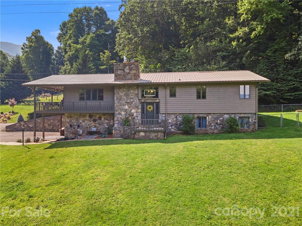 1004 Lickstone Road Waynesville, NC 28786 - Photo 2 of 39 a front view of a house with garden