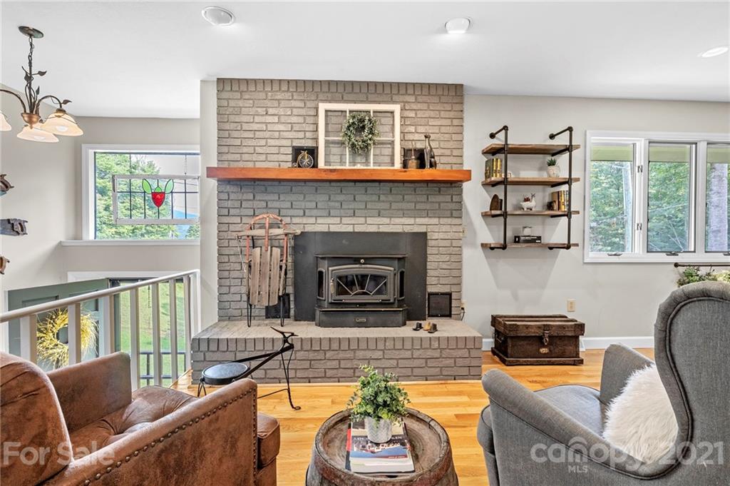 1004 Lickstone Road Waynesville, NC 28786 - Photo 12 of 39 a living room with furniture and a fireplace