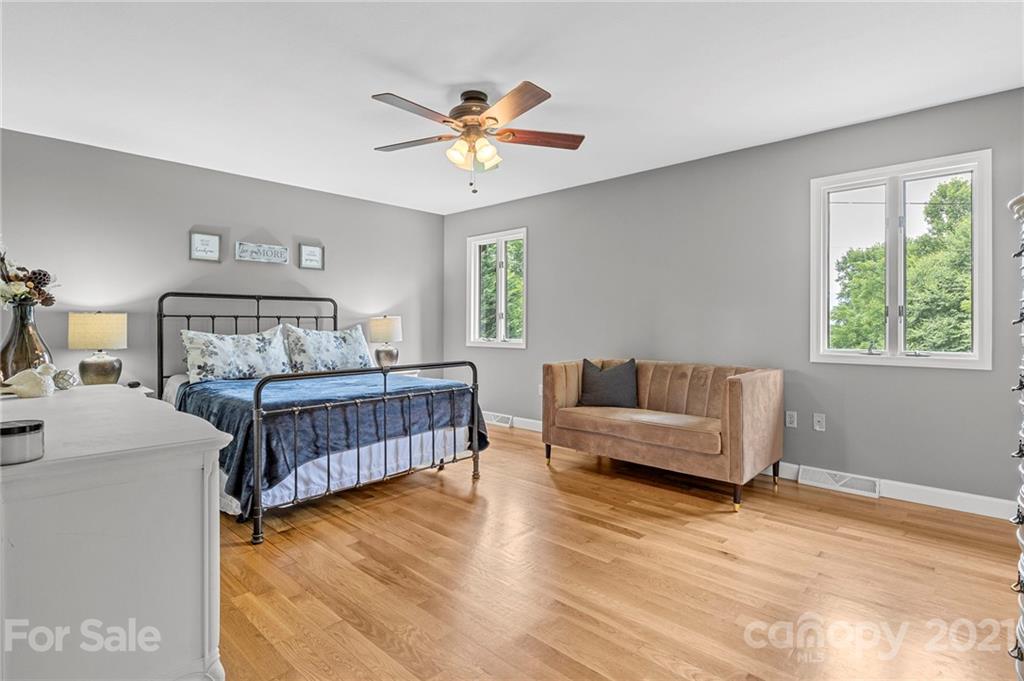 1004 Lickstone Road Waynesville, NC 28786 - Photo 18 of 39 a bedroom with a bed and a dresser