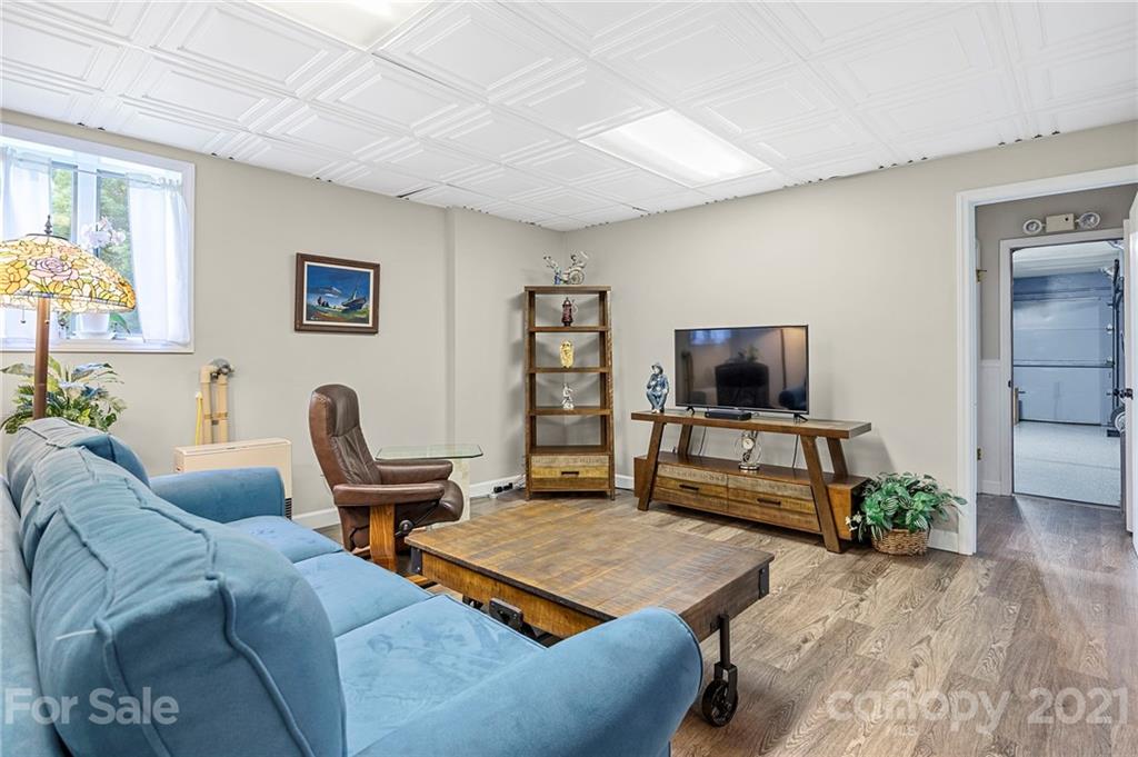 1004 Lickstone Road Waynesville, NC 28786 - Photo 24 of 39 a living room with furniture and a flat screen tv