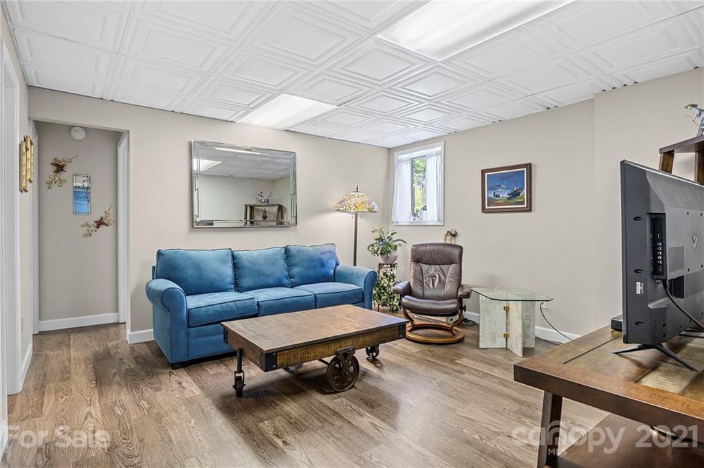 1004 Lickstone Road Waynesville, NC 28786 - Photo 25 of 39 a living room with furniture and a flat screen tv