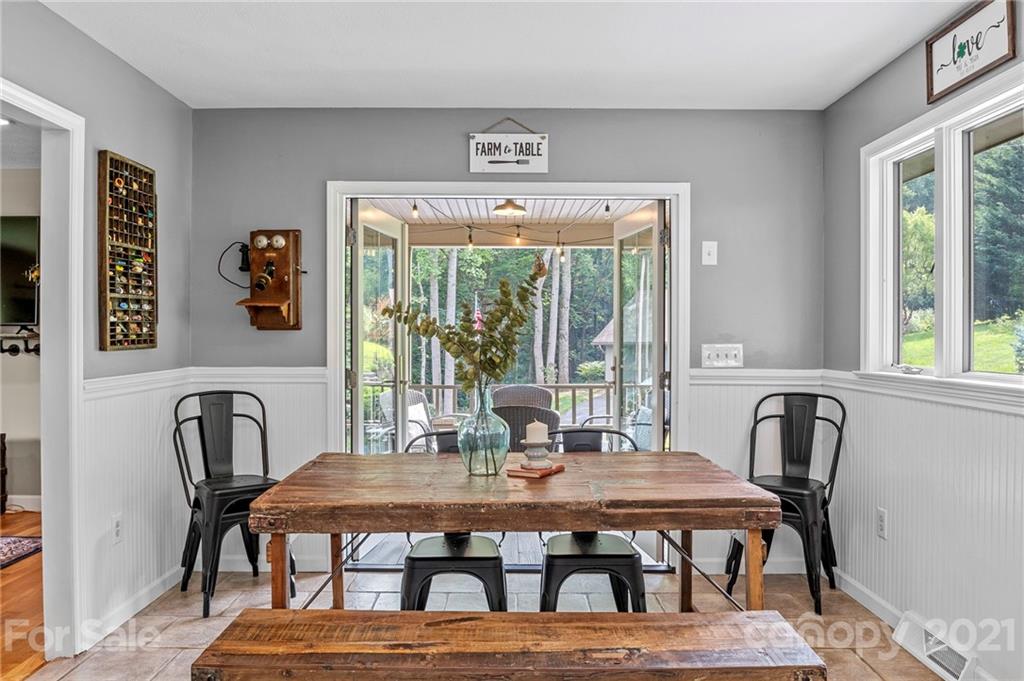 1004 Lickstone Road Waynesville, NC 28786 - Photo 6 of 39 a view of a dining room with furniture window and outside view