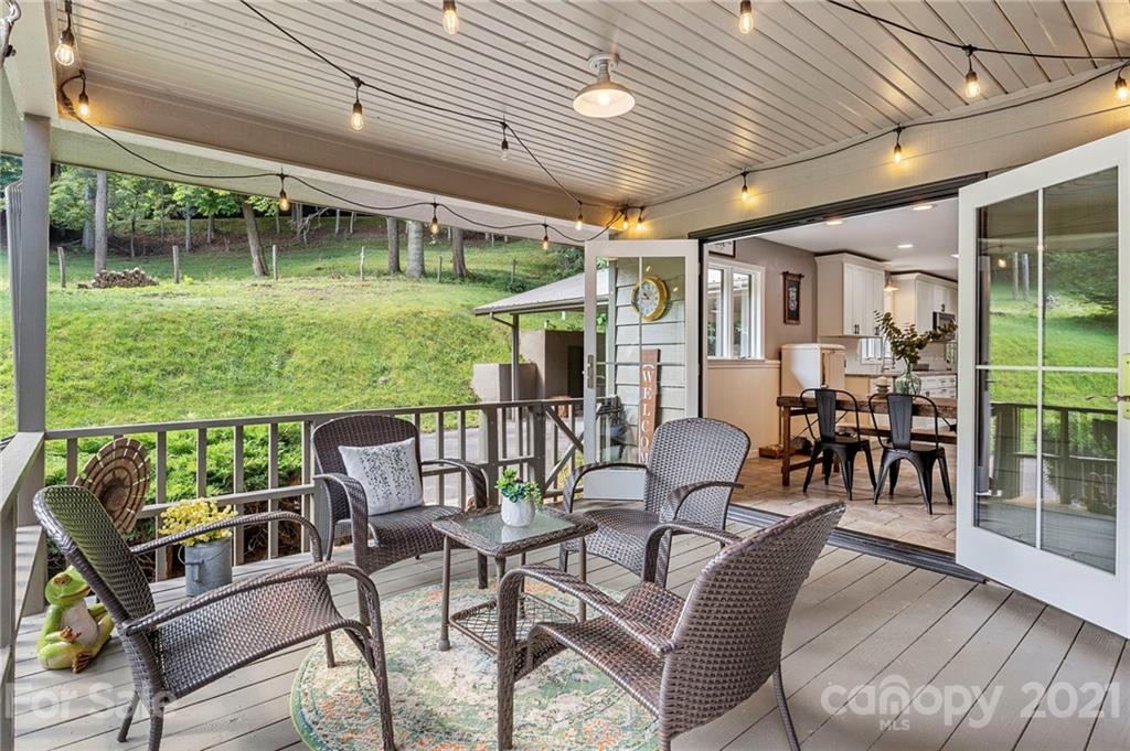 1004 Lickstone Road Waynesville, NC 28786 - Photo 8 of 39 a view of a patio with couches chairs dining table and chairs