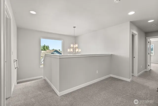 a kitchen with kitchen island a sink appliances and cabinets