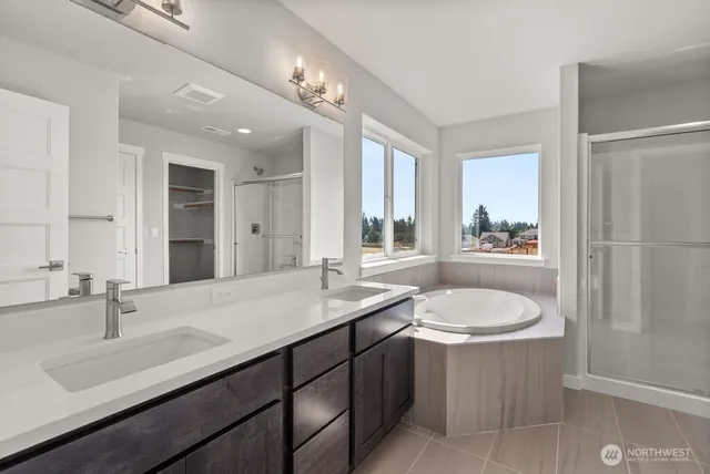 a bathroom with a sink double vanity granite and a mirror
