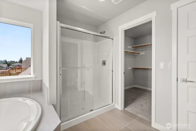 a bathroom with a tub and a bathroom