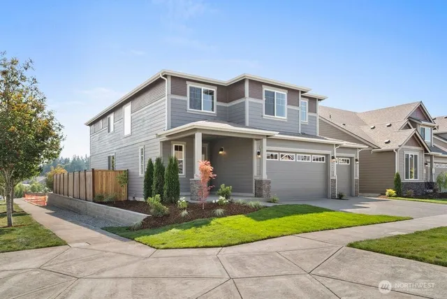 a front view of a house with a yard and potted plants