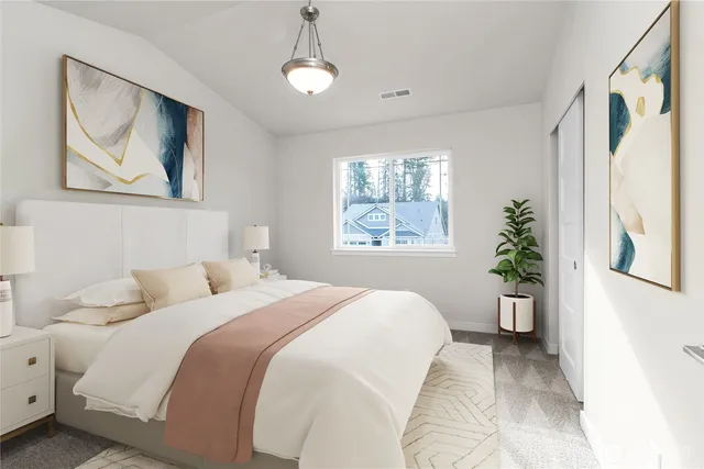 a bedroom with a large bed and a window