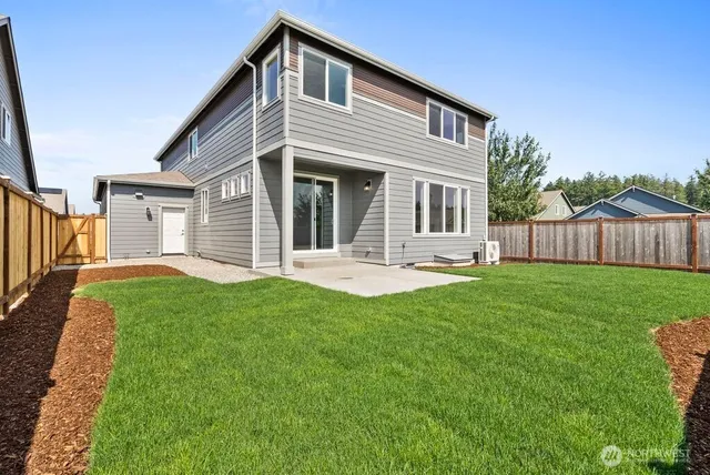 a front view of a house with yard and green space