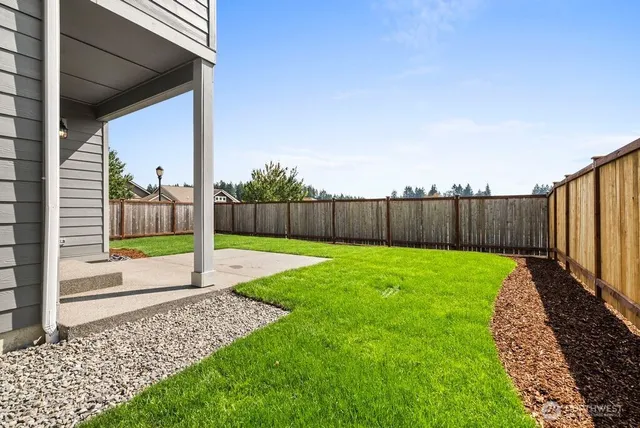 a view of a backyard with fence