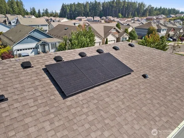 an aerial view of a house with a yard