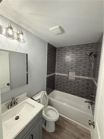 a bathroom with a sink mirror toilet and bathtub