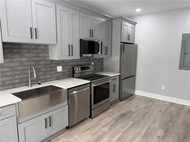 a kitchen with stainless steel appliances a sink stove and refrigerator