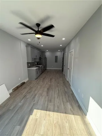 a view of a kitchen with a sink and wooden floor