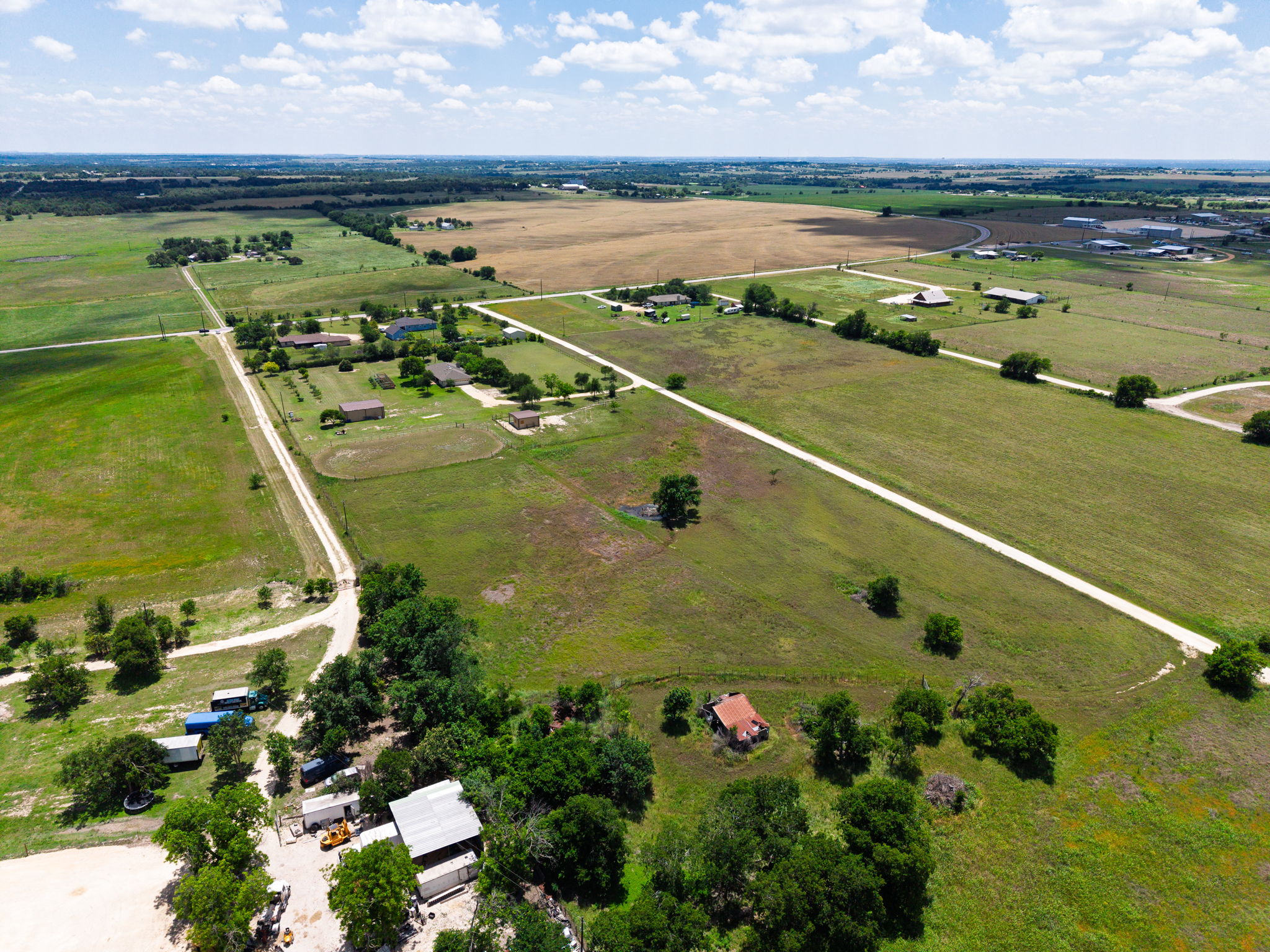 120 Rae Lane Jarrell, TX 76537 - Photo 40 of 40 Expansive land parcel featuring a network of unpaved roads, multiple established structures, mature trees, and open fields
