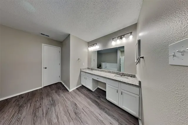 a large bathroom with a double vanity sink and mirror