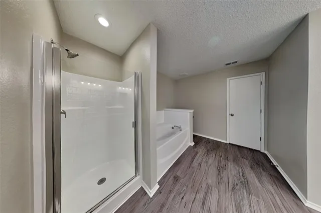 a bathroom with a bathtub and a shower