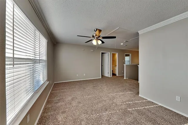 a view of a livingroom with a ceiling fan and window