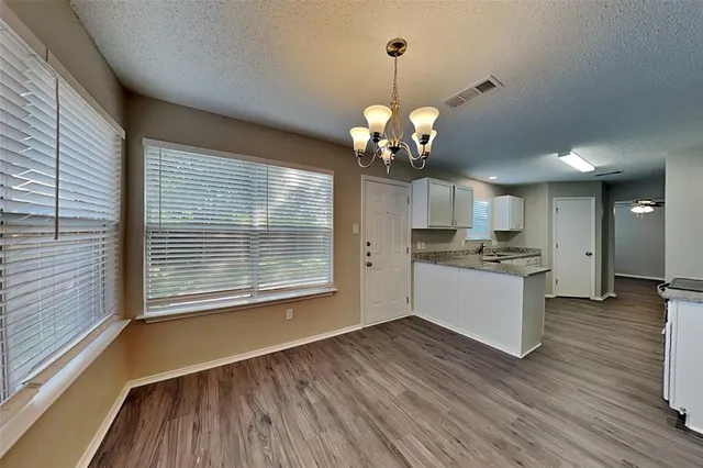a view of a kitchen counter space wooden floor and a kitchen