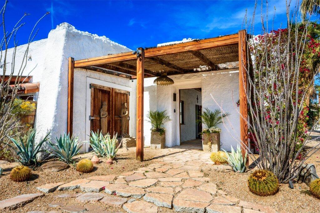 71607 Sahara Road Rancho Mirage, CA 92270 - Photo 5 of 118 a view of a house with potted plants and floor to ceiling window