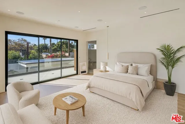 a bathroom with a tub and a large window
