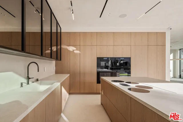 a kitchen that has a sink and a stove