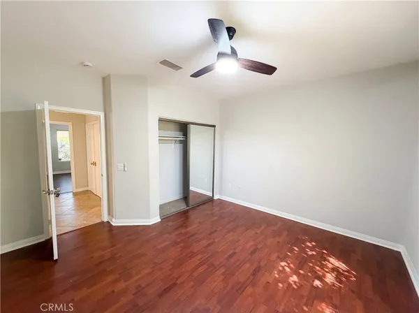 a view of an empty room and wooden floor