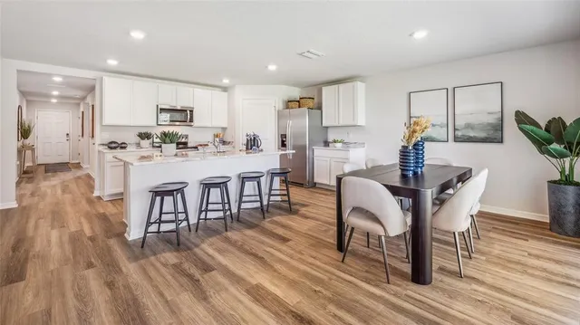 a dining room with furniture and wooden floor