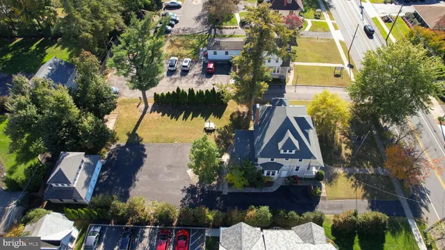a view of a house with a yard and potted plants