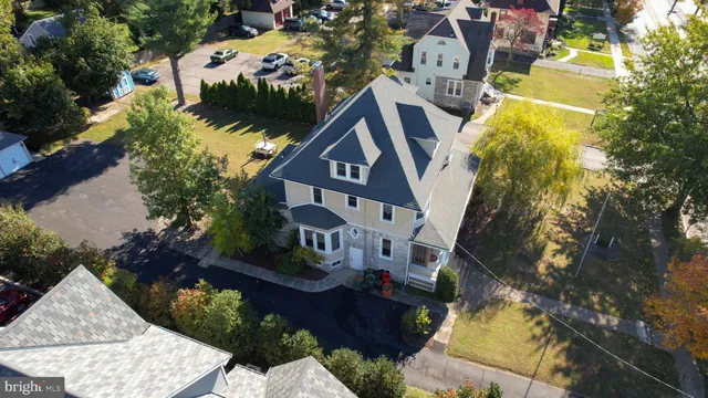 a kitchen with granite countertop kitchen island stainless steel appliances a sink and a living room view