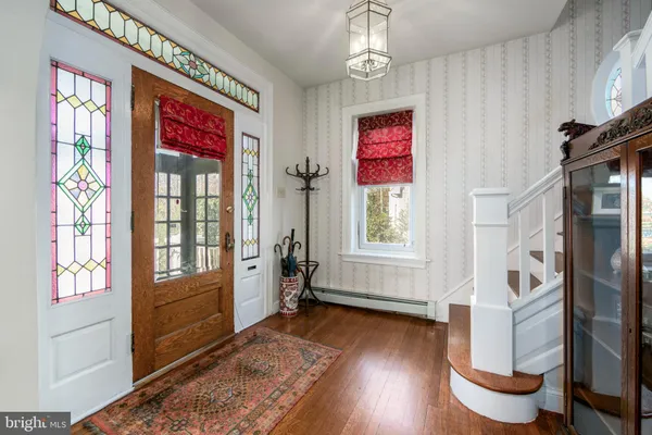 a living room with furniture a rug and a window