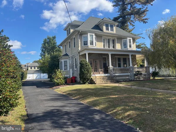 a front view of a house with a yard porch and outdoor seating