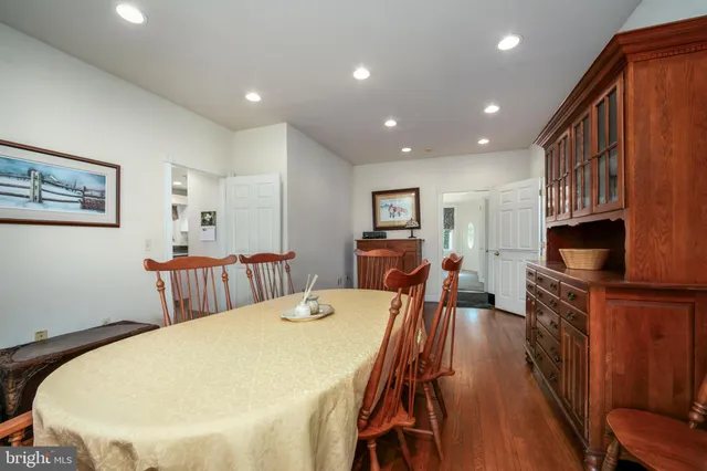 a spacious bathroom with a double vanity sink toilet and a mirror