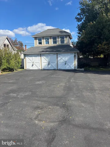 an aerial view of residential house with outdoor space and trees all around
