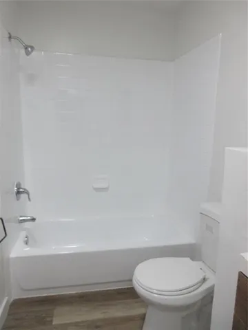 a bathroom with a toilet and a bathtub