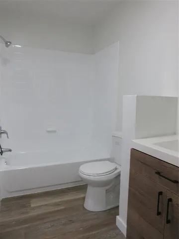 a bathroom with a toilet and a bathtub