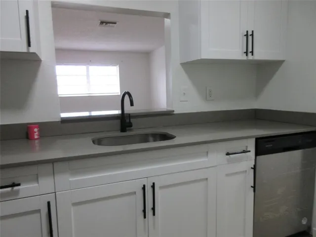 a kitchen with a sink and cabinets