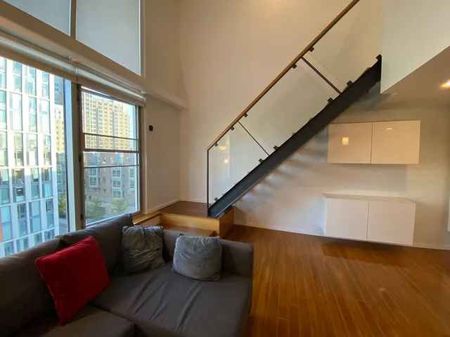 a living room with furniture and stairs