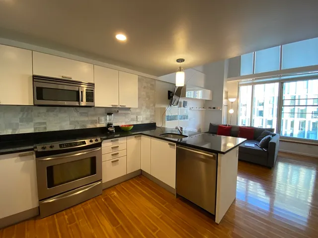 a kitchen with a stove a sink and a microwave
