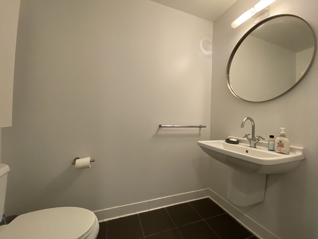 1 Earhart Street, Unit 702 Cambridge, MA 02141 - Photo 5 of 19 a bathroom with a sink mirror and toilet