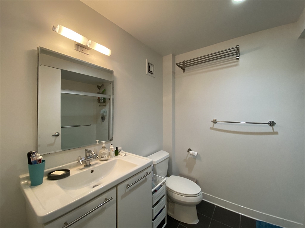 1 Earhart Street, Unit 702 Cambridge, MA 02141 - Photo 7 of 19 a bathroom with a sink toilet and a mirror