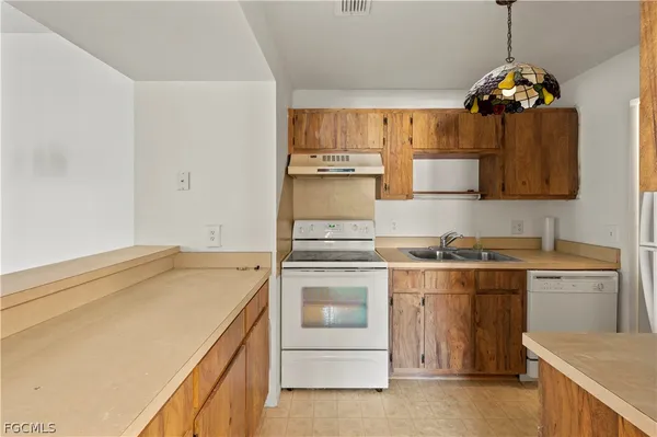 a kitchen with a stove and a sink