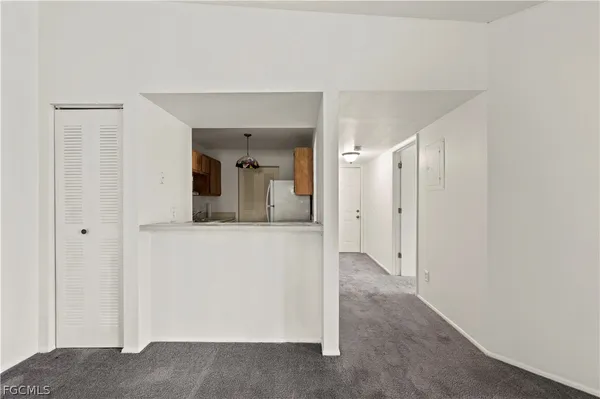 an empty room with a ceiling fan and bathroom