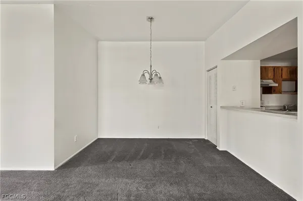 a view of a big room with chandelier fan and windows