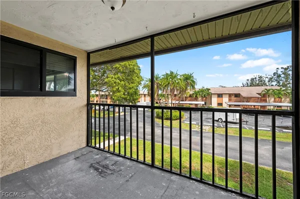 a view of a hallway with wooden floor and stairs