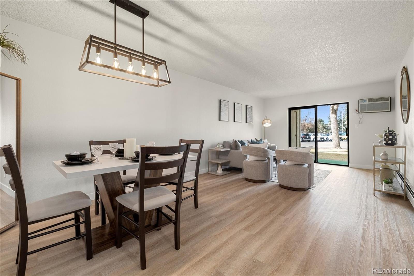 a living room with furniture wooden floor and a window