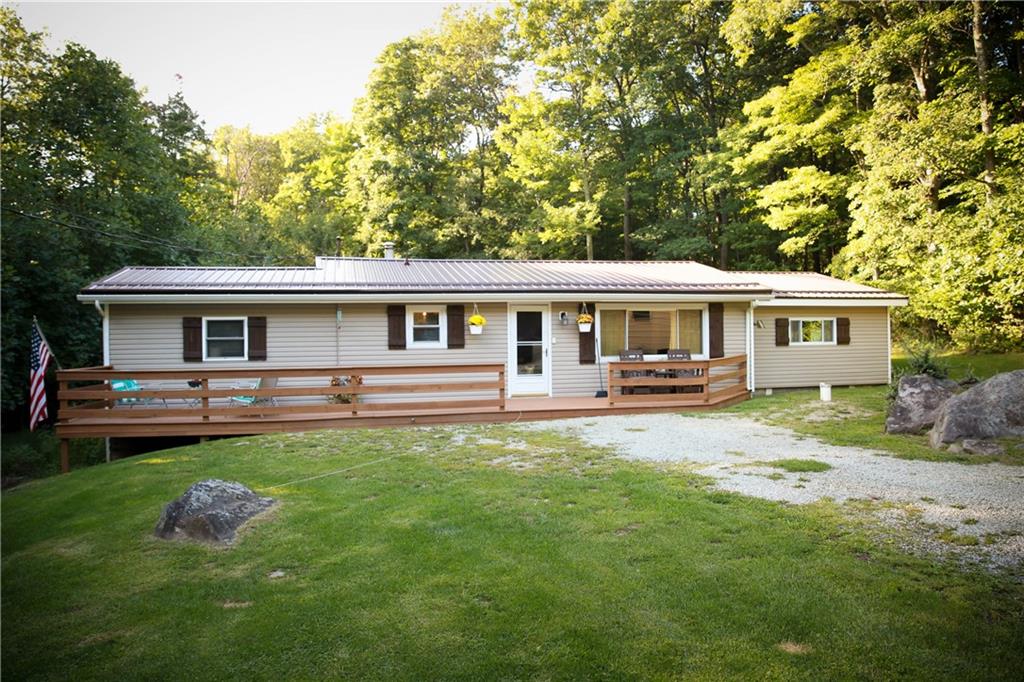 75 Spruce Peak Road Acme, PA 15610 - Photo 1 of 25 a front view of a house with yard patio and swimming pool