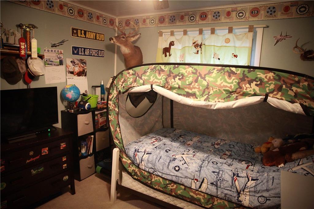 75 Spruce Peak Road Acme, PA 15610 - Photo 15 of 25 a bed sitting in a bedroom next to a window