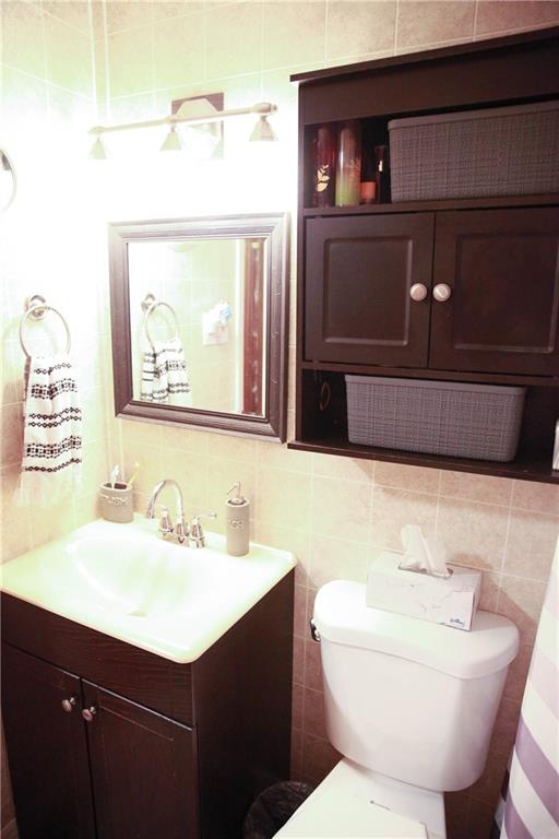 75 Spruce Peak Road Acme, PA 15610 - Photo 16 of 25 a bathroom with a sink mirror and toilet
