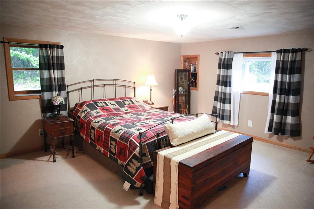 75 Spruce Peak Road Acme, PA 15610 - Photo 21 of 25 a bedroom with a bed and a dresser next to a window